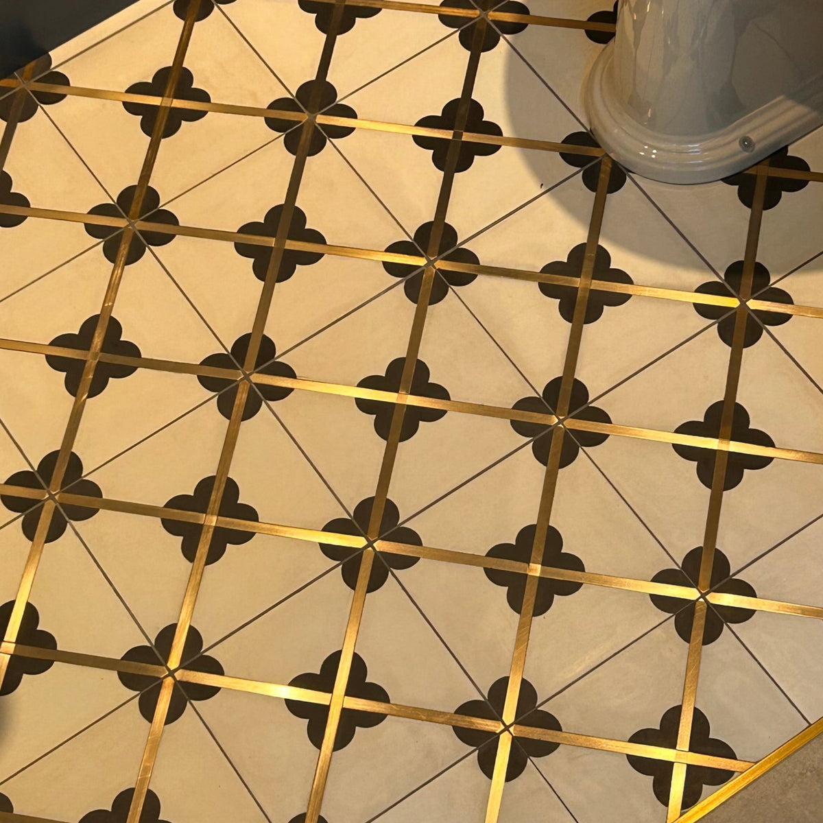 Handmade with solid brass cross section inside black and white cement tile.