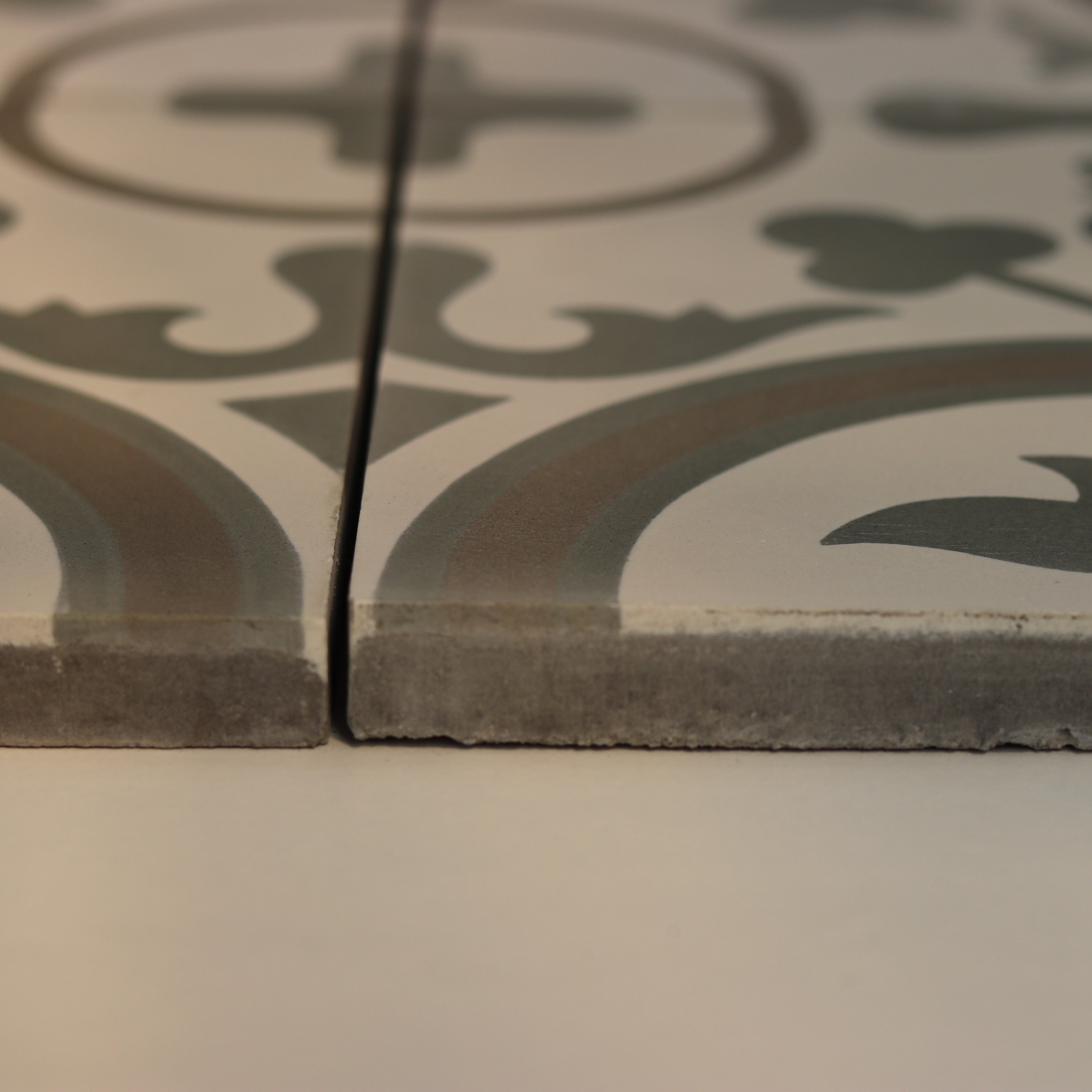 Close-up of a decorative tile with intricate patterns on a plain background