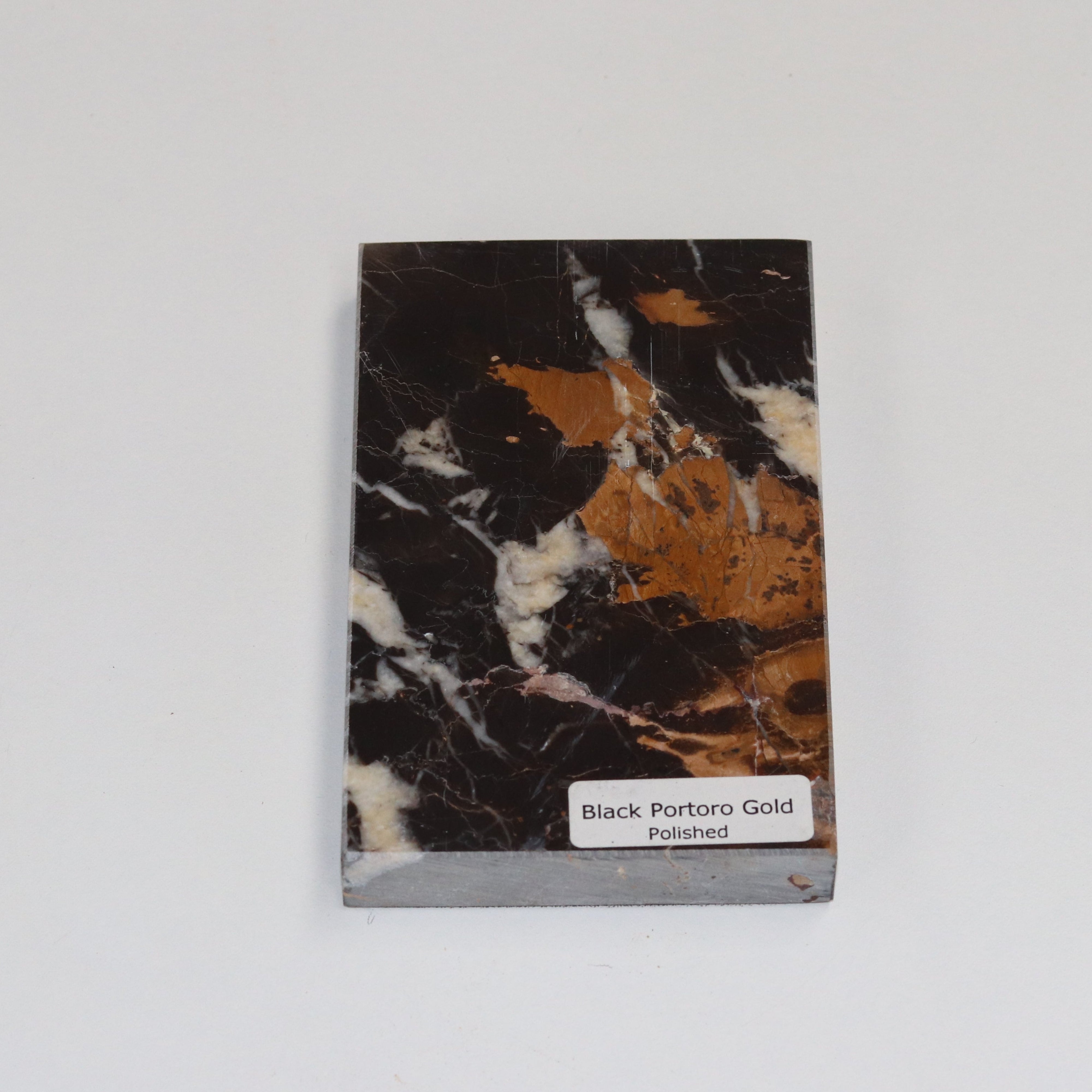 Polished Portoro Gold — high‑gloss surface with vivid golden veining