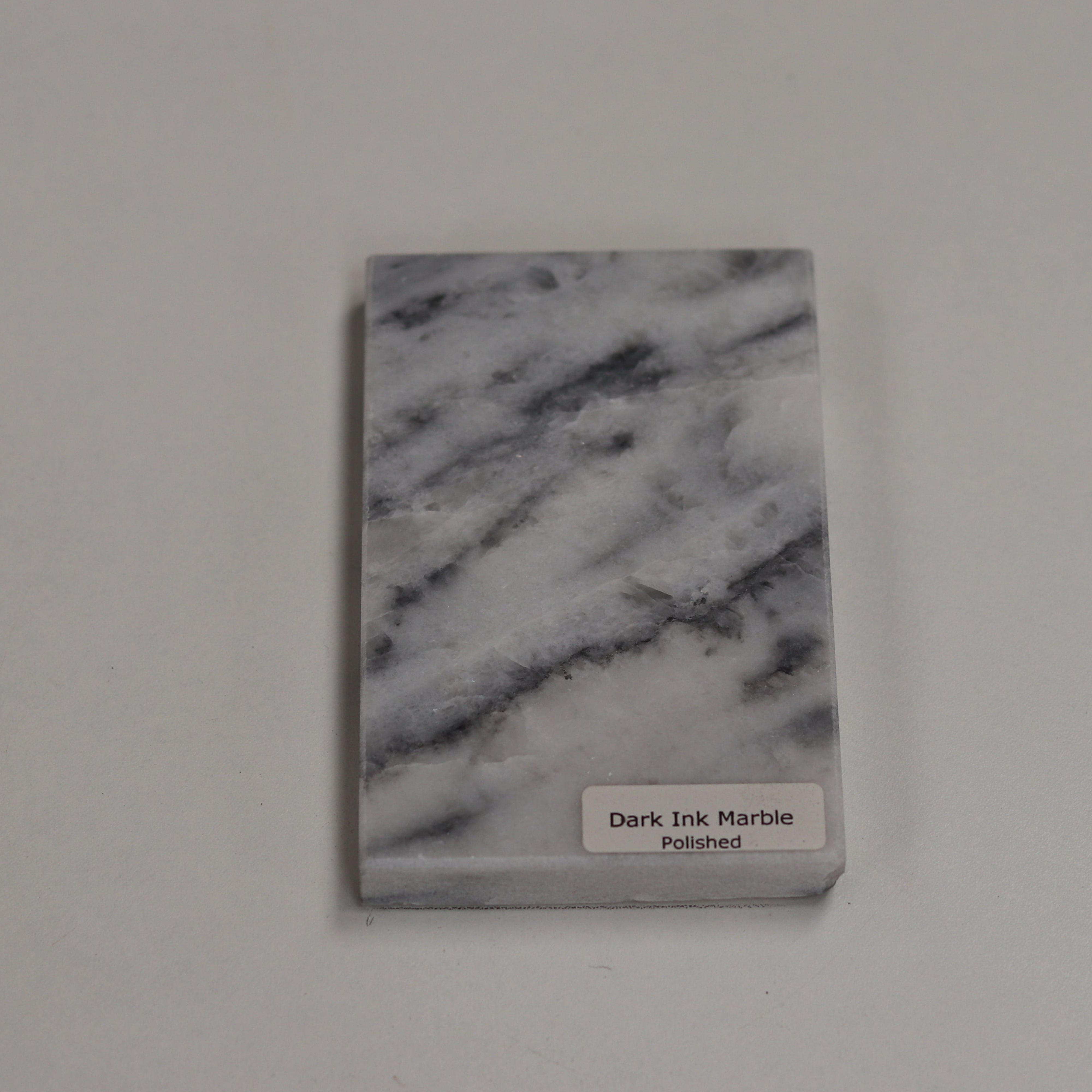 Polished Dark Ink — high‑gloss surface with deep charcoal richness
