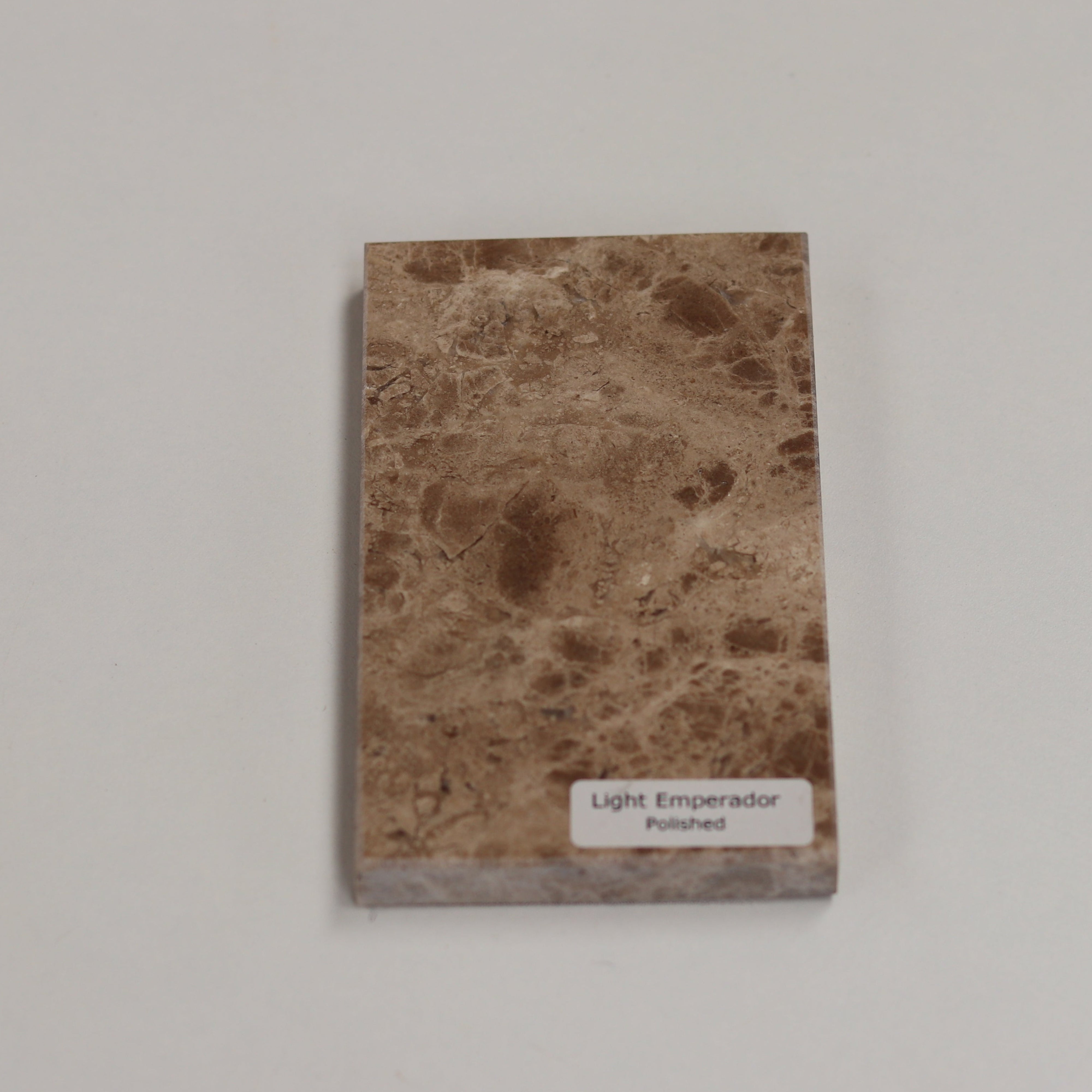 Polished Light Emperador — high‑gloss surface with rich creamy depth