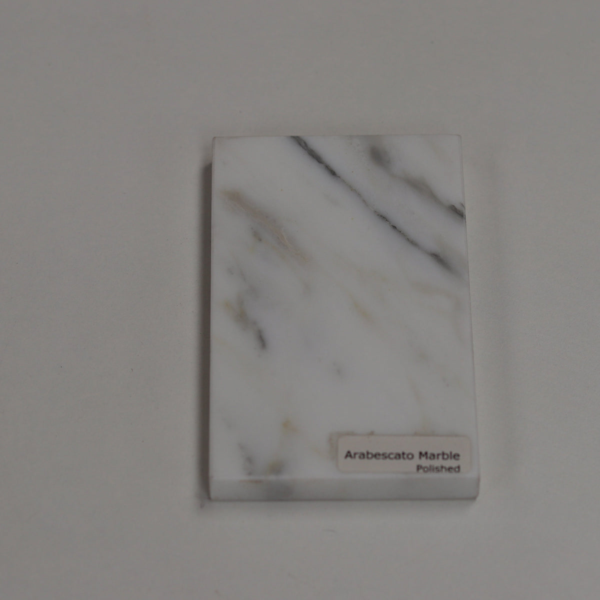 Polished Arabescato — high‑gloss surface with dramatic grey contrast