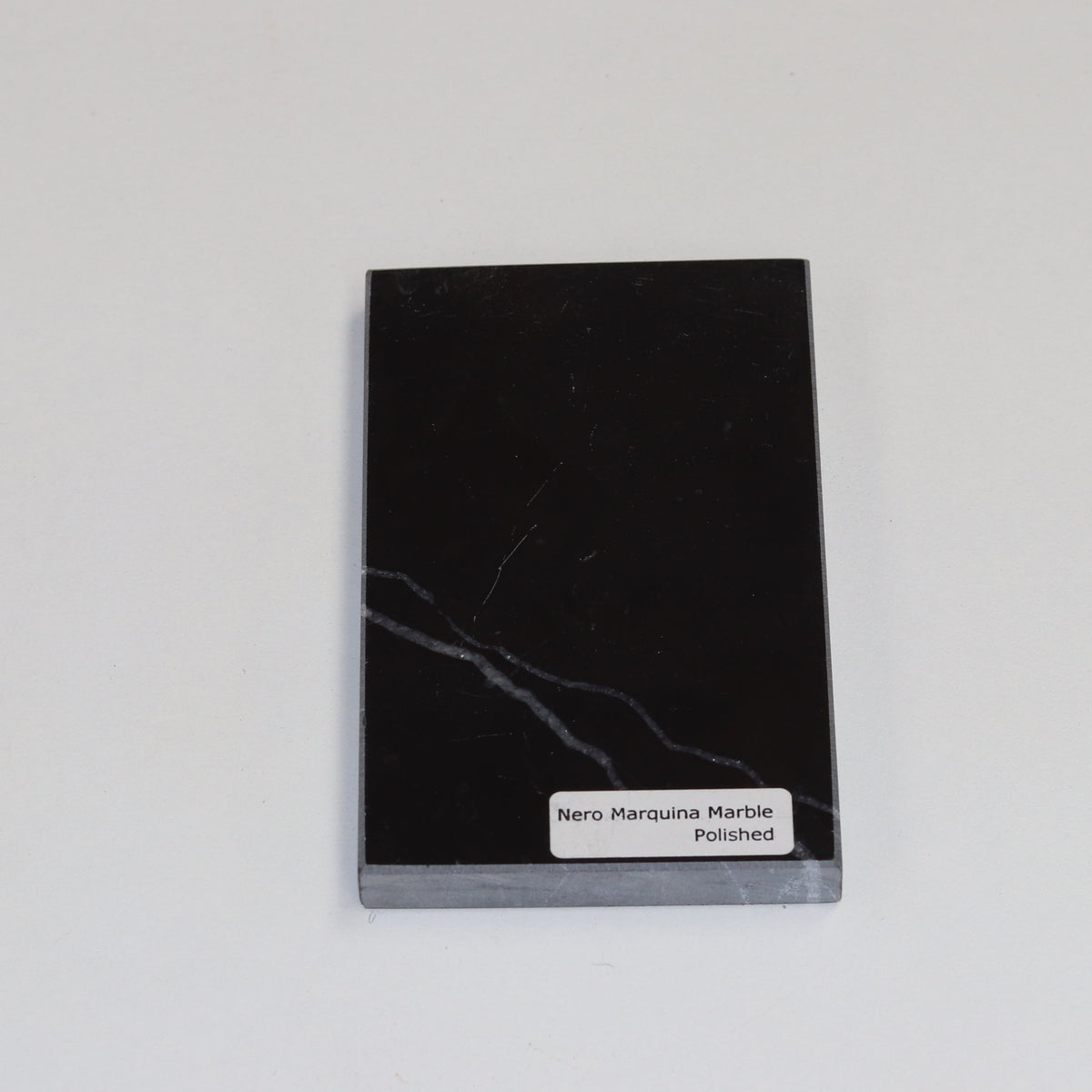 Polished Nero Marquina — high‑gloss surface with intense black depth