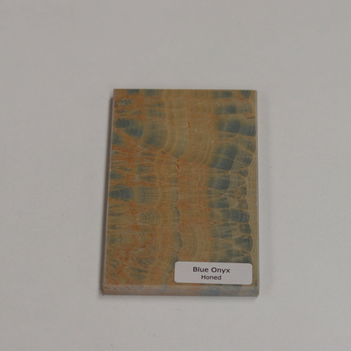 Honed Blue Onyx — soft matte texture with fluid blue banding