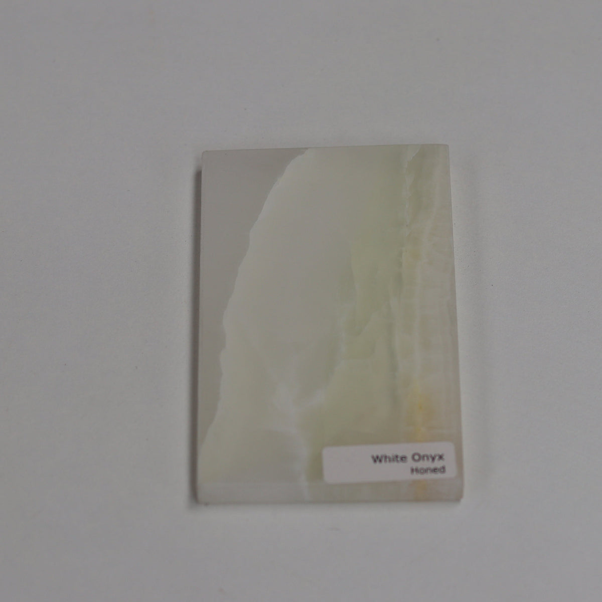 Honed White Onyx — soft matte texture with gentle cloud‑like banding