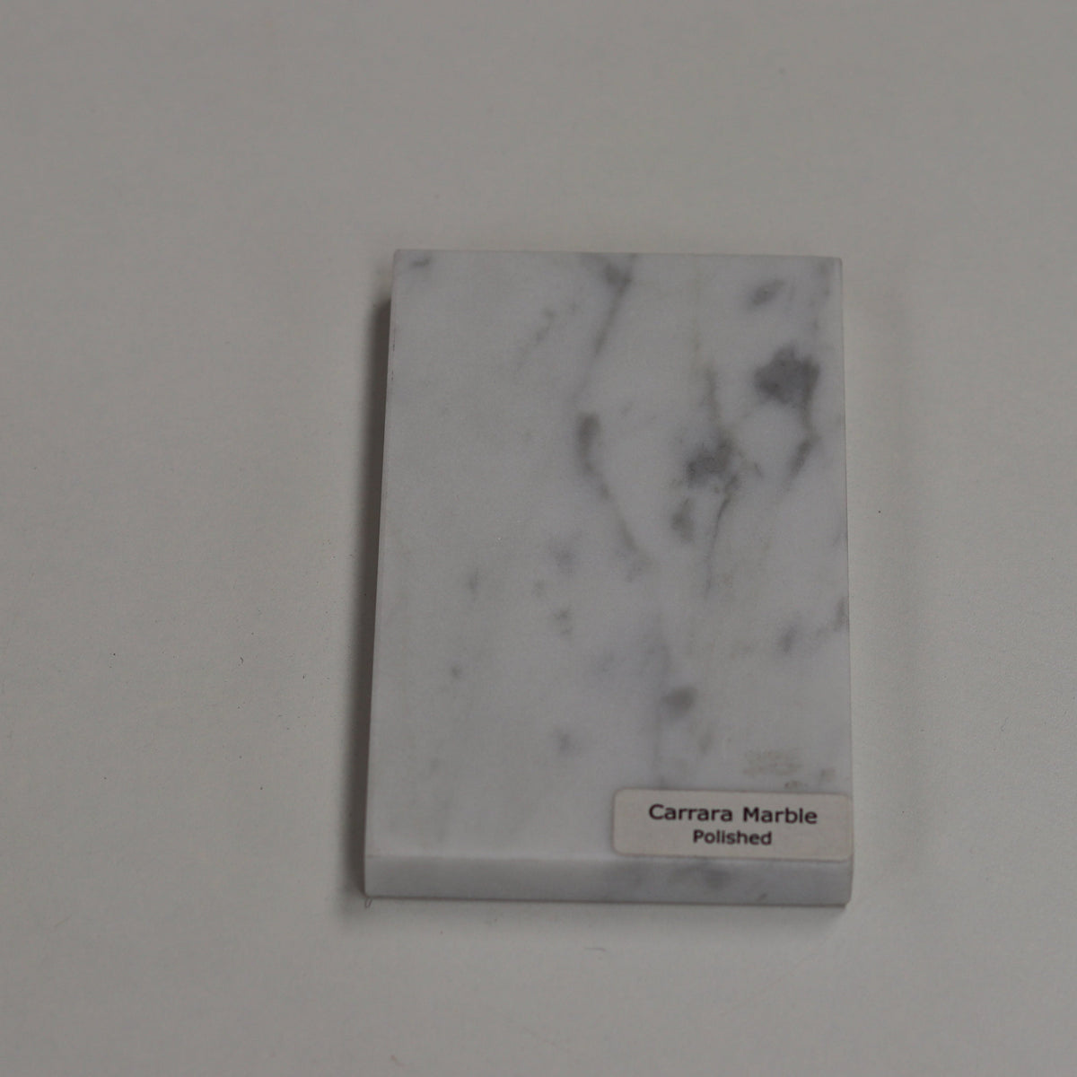 Polished Carrara — high‑gloss surface with bright white depth