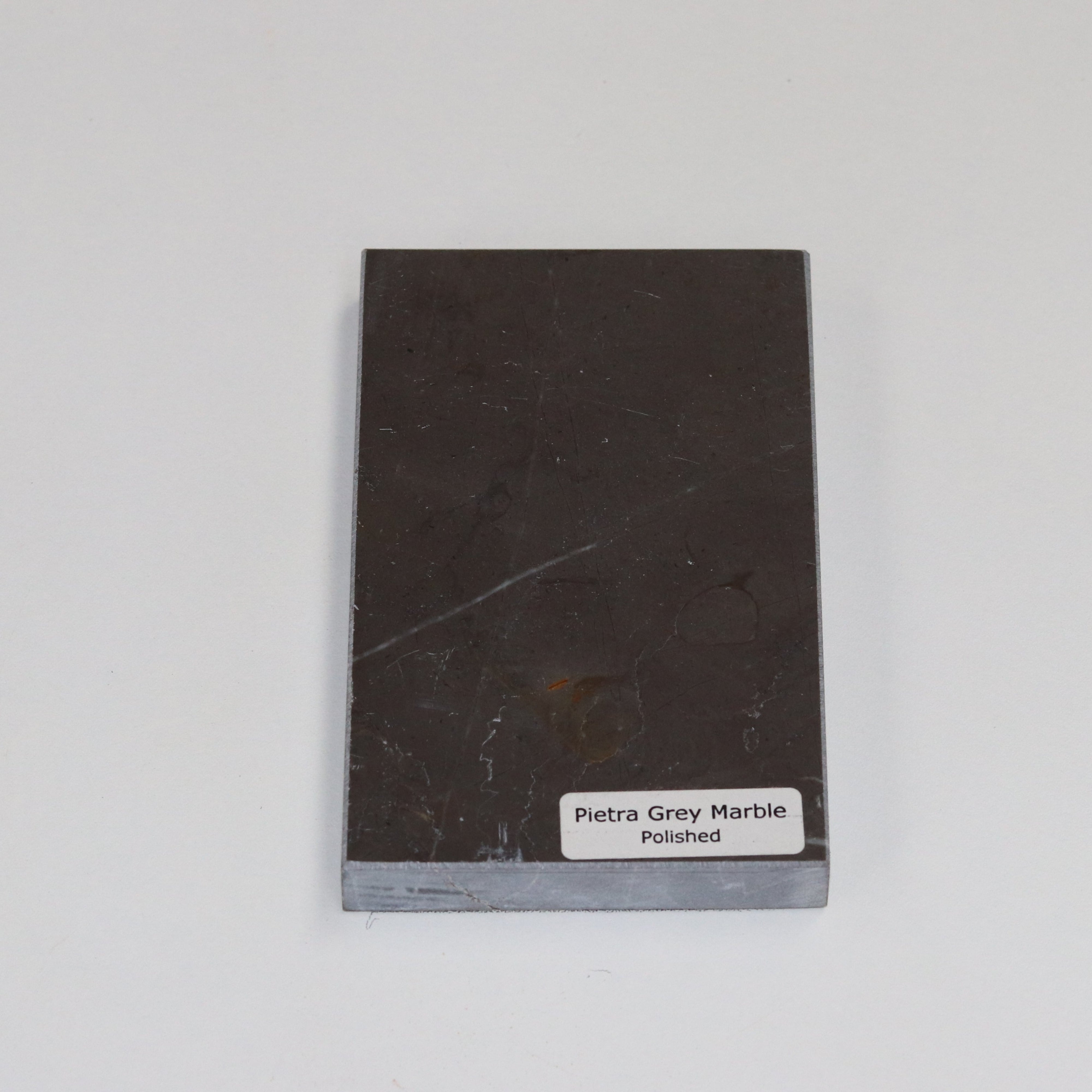 Polished Pietra Grey — high‑gloss surface with crisp white veining