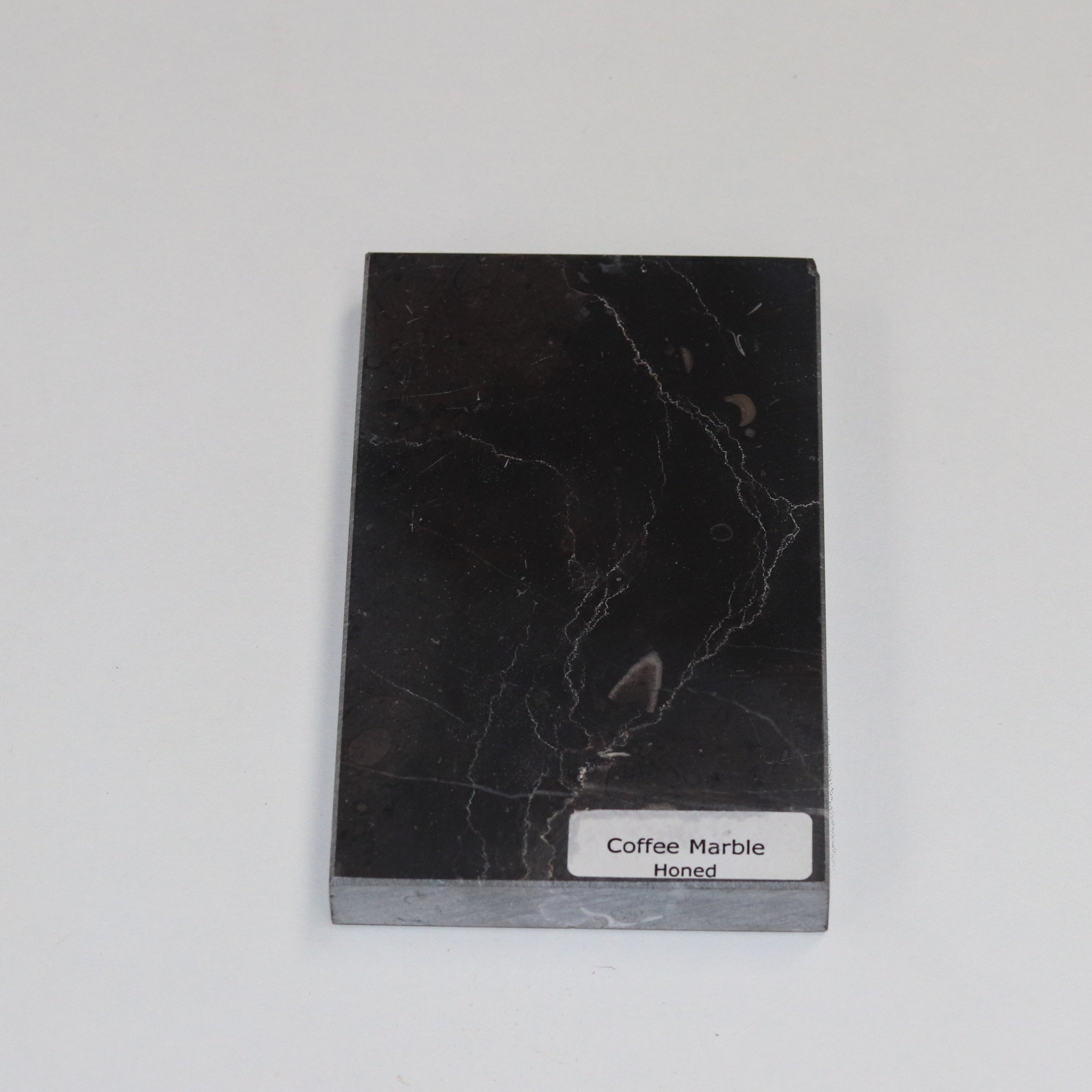 Honed Coffee Marble — soft matte texture with warm brown tones