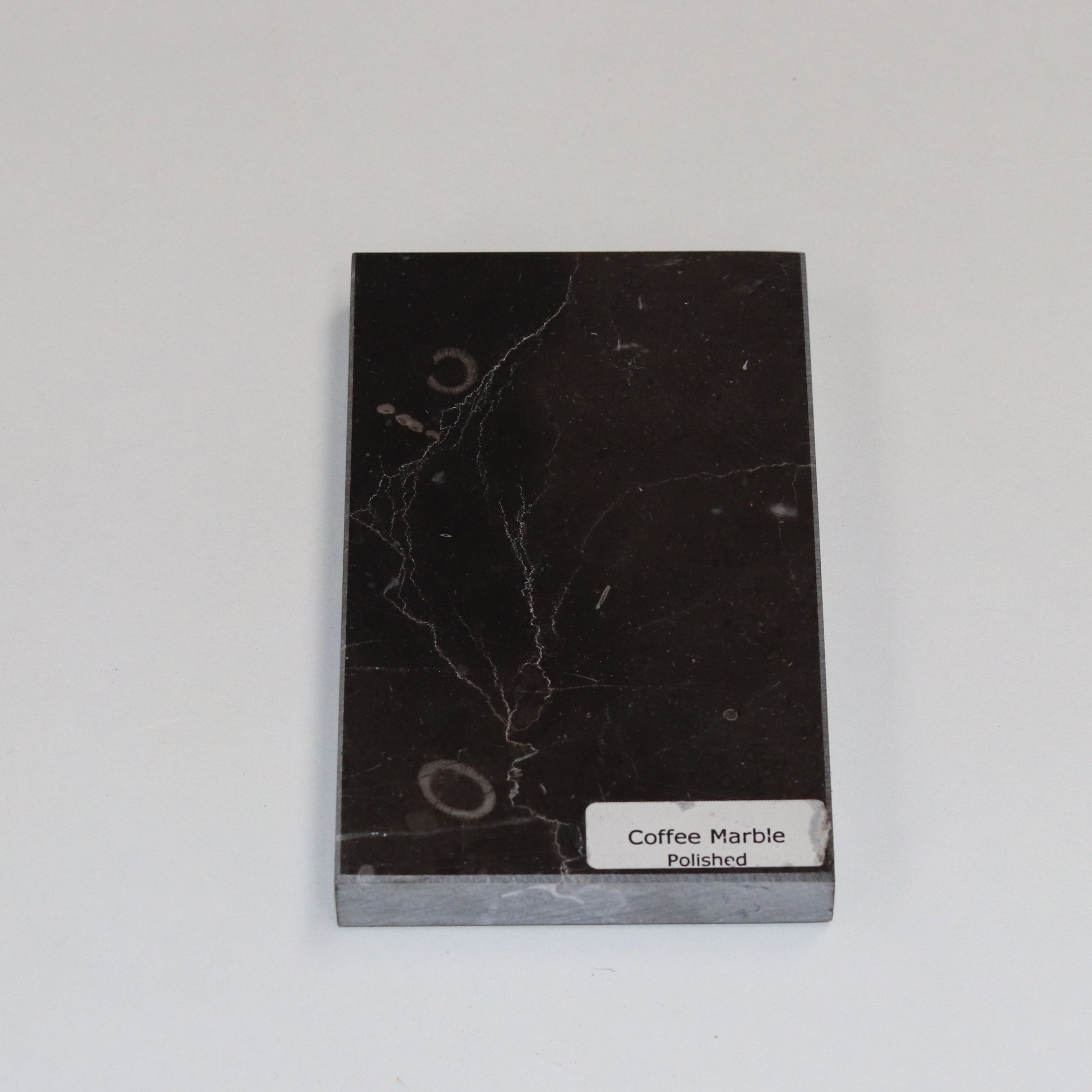 Polished Coffee Marble — high‑gloss surface with rich chocolate depth
