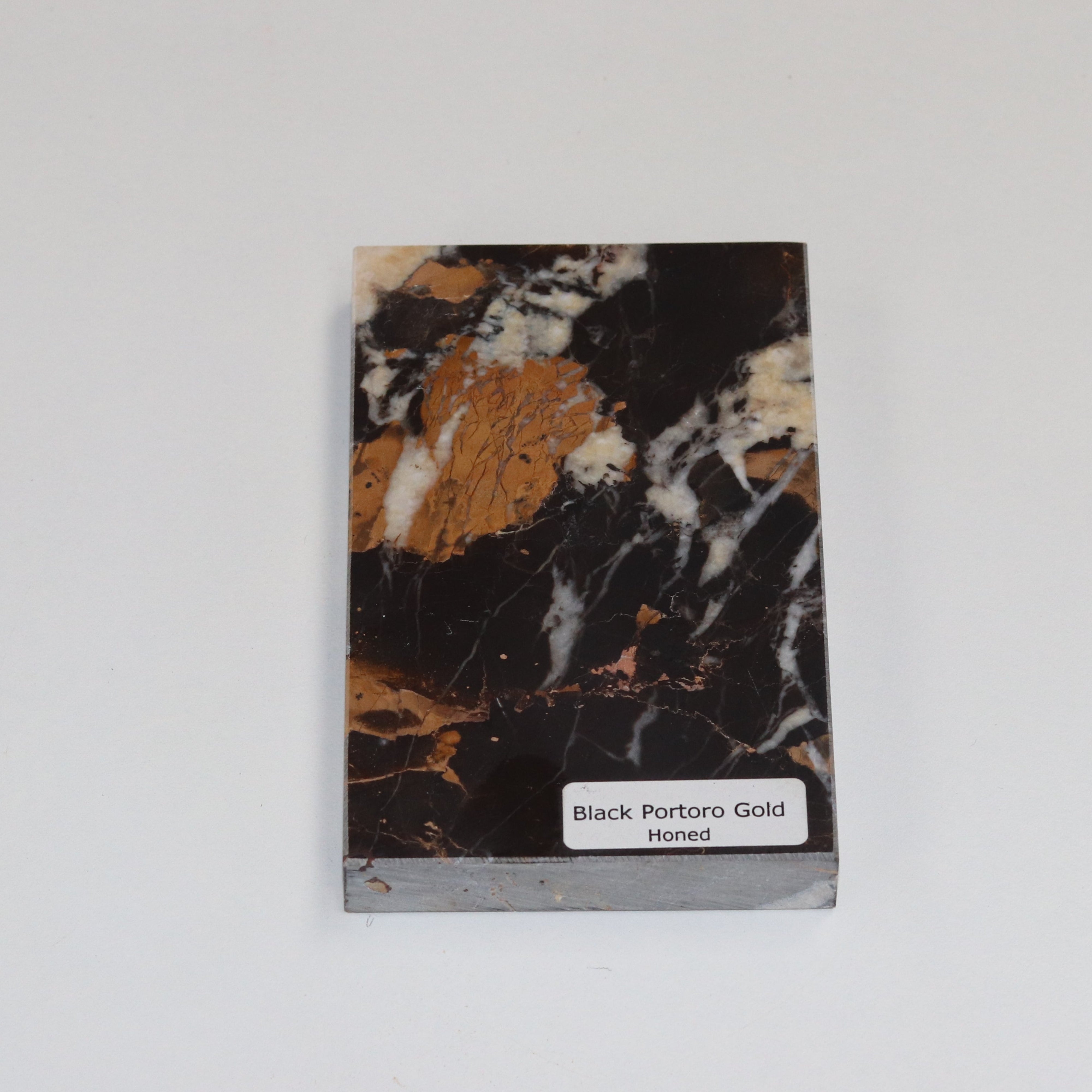 A velvety surface that softens Portoro’s dramatic black‑and‑gold patterning