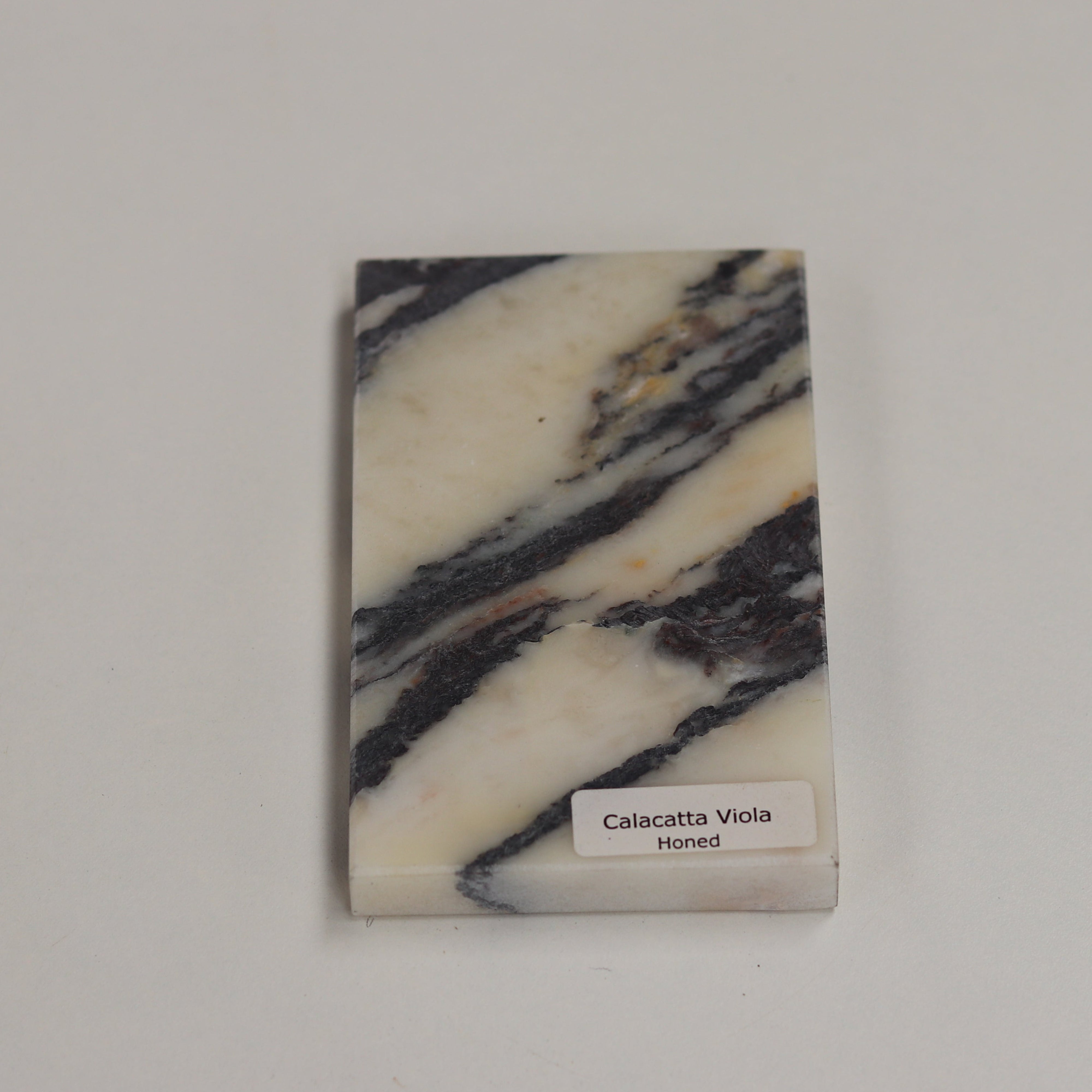 Honed Calacatta Viola — soft matte texture with rich violet veining