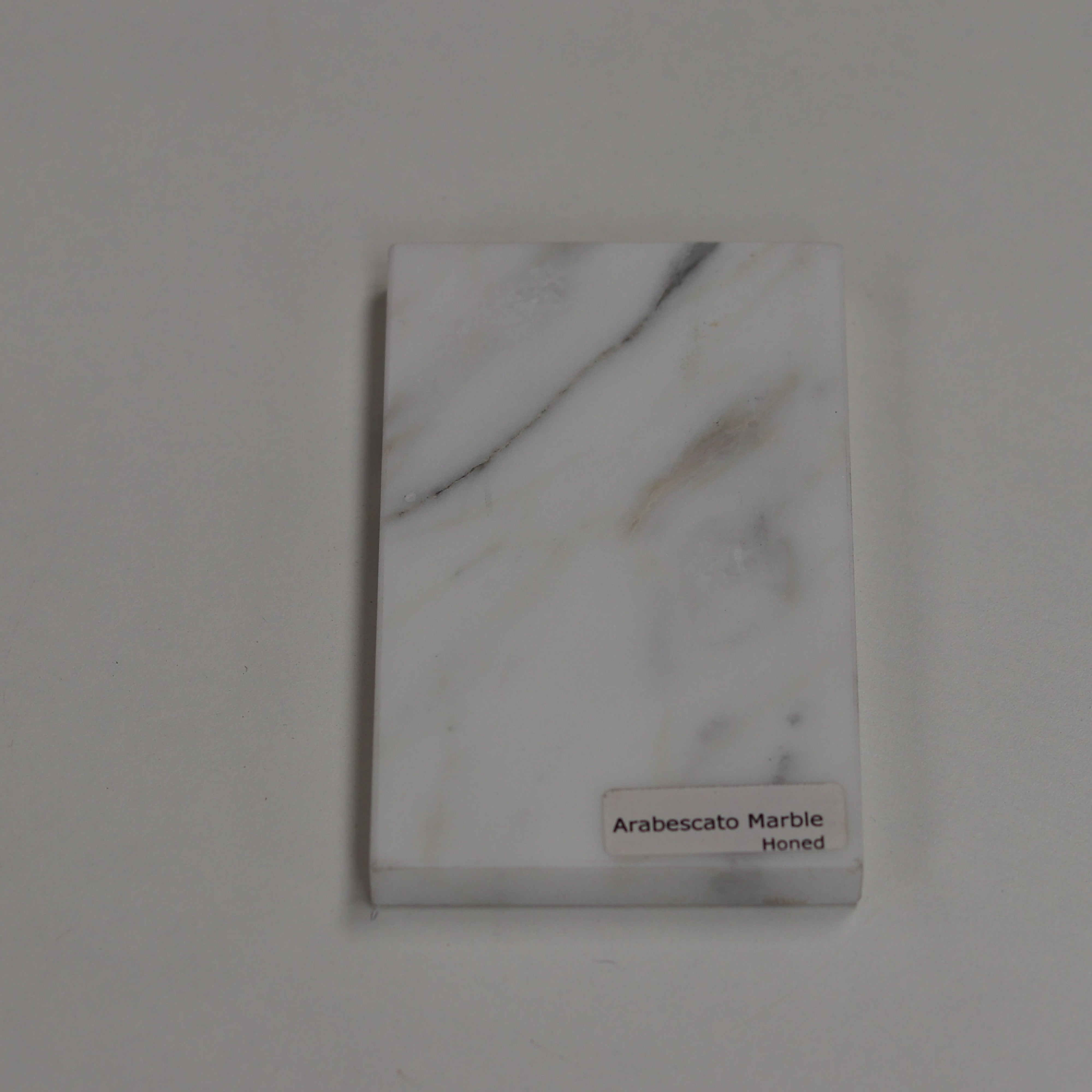 Honed Arabescato — soft matte texture with expressive grey veining