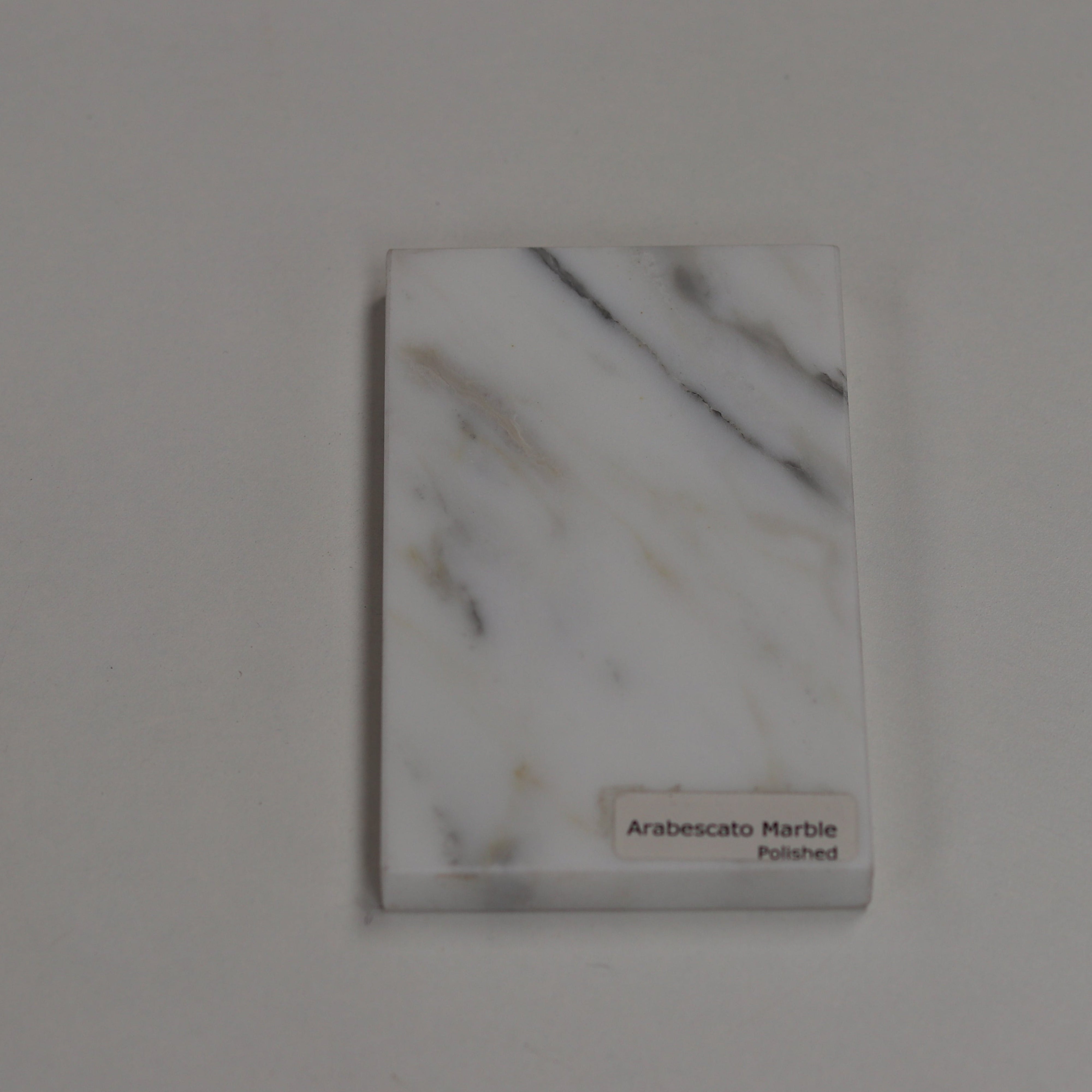 Polished Arabescato — high‑gloss surface with dramatic grey contrast
