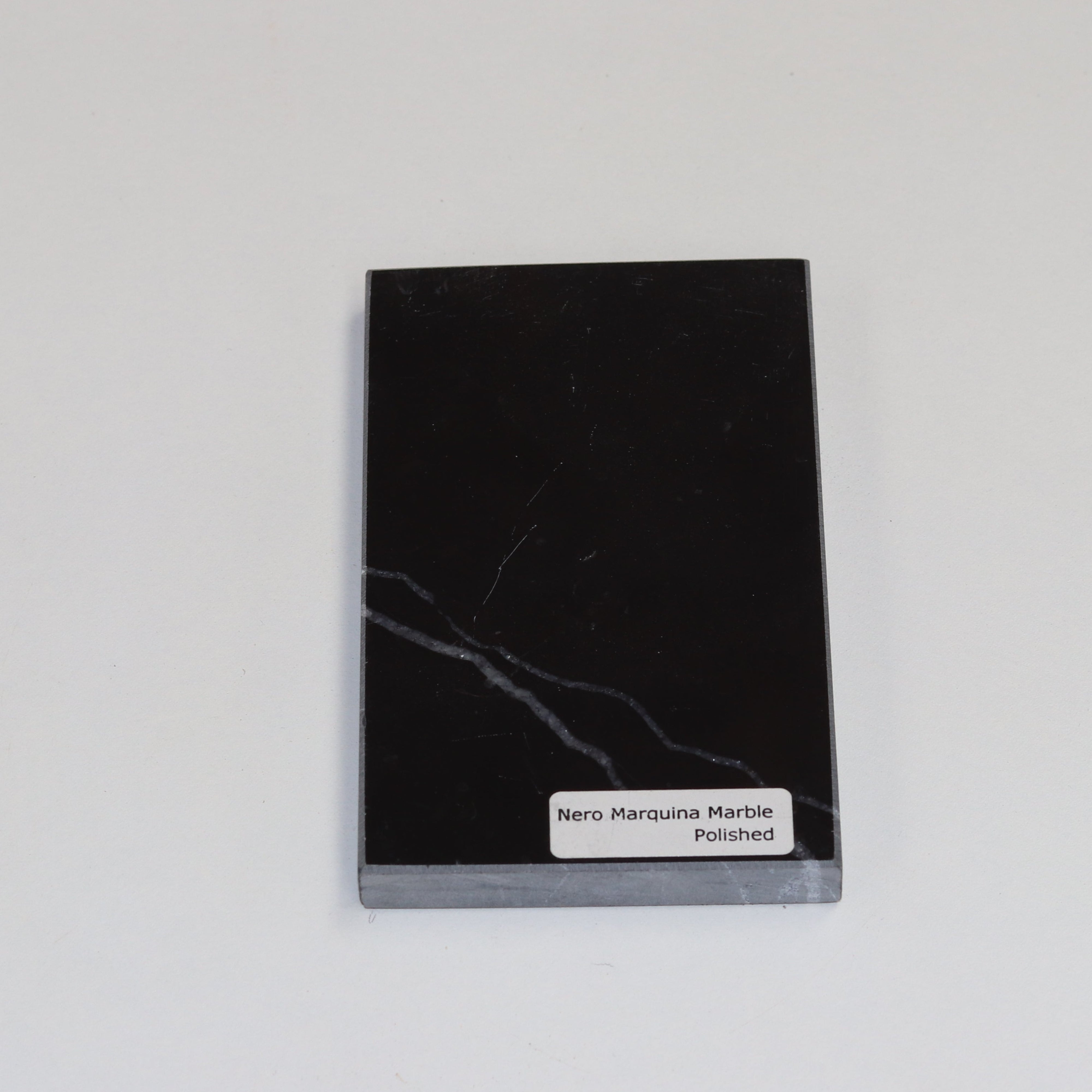 Polished Nero Marquina — high‑gloss surface with intense black depth