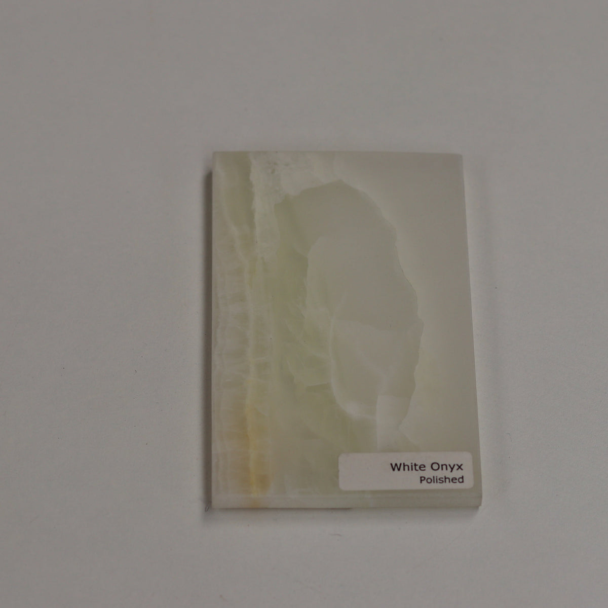 Polished White Onyx — high‑gloss surface with luminous depth